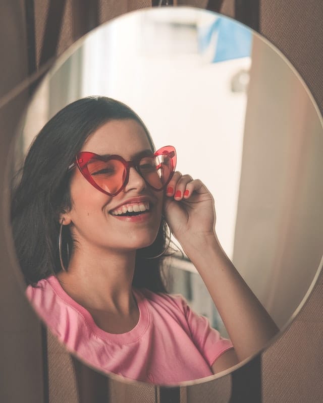 smiling woman wearing red sunglasses 2157086